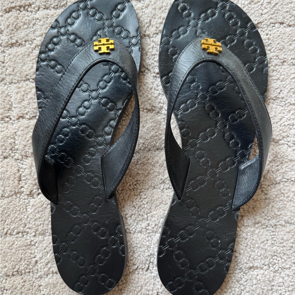 Tory Burch Black Flip Flops with Gold Logo and Leather straps.